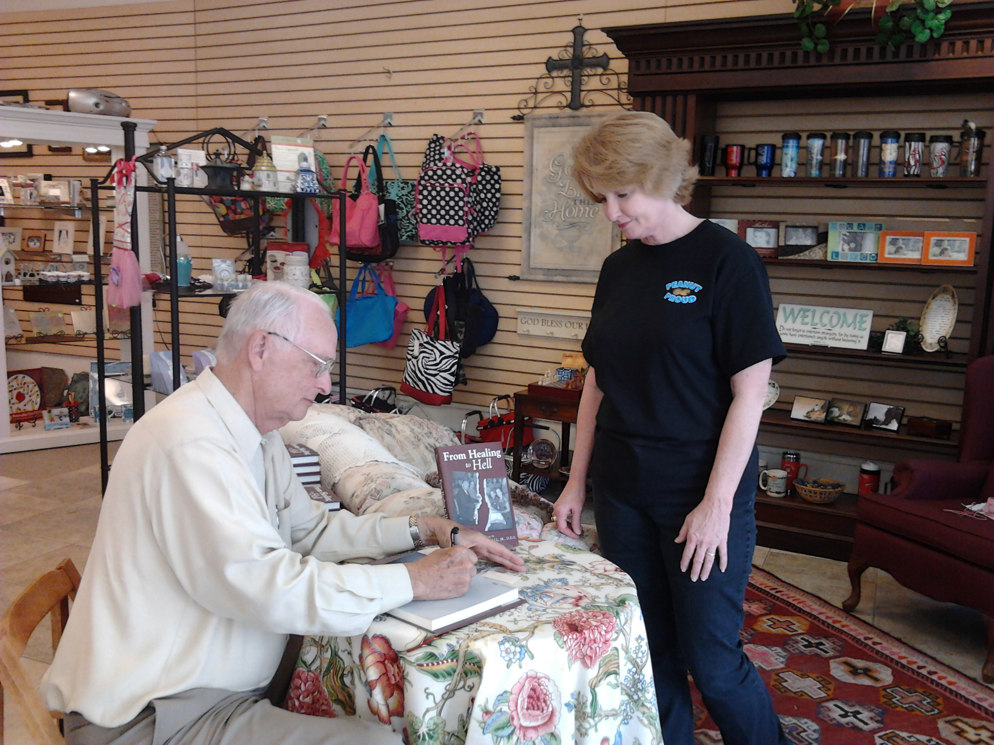 Henry Wall autographs a copy of his book